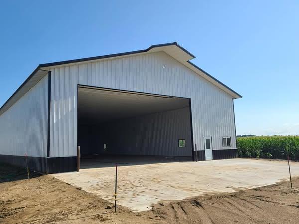 Clean professional commercial post-frame exterior with hidden-fastener panels